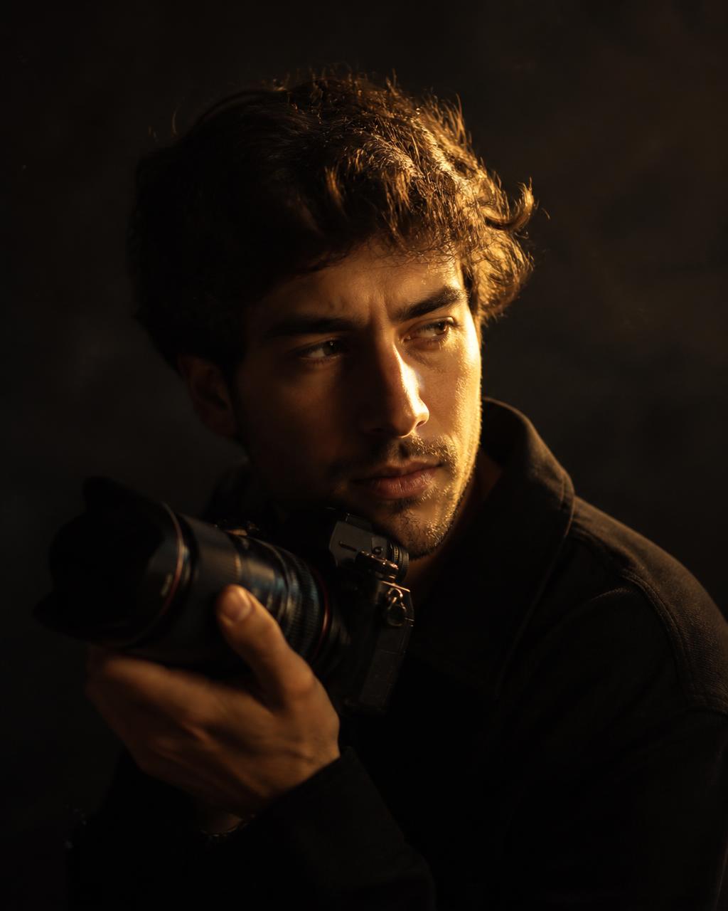 Portrait of Nick holding his camera